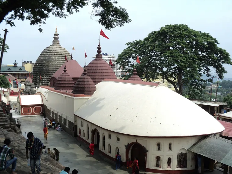 The beehive-shaped dome and white-roofed halls of the Kamakhya Temple on Nilachal hill in Guwahati, seen from above
