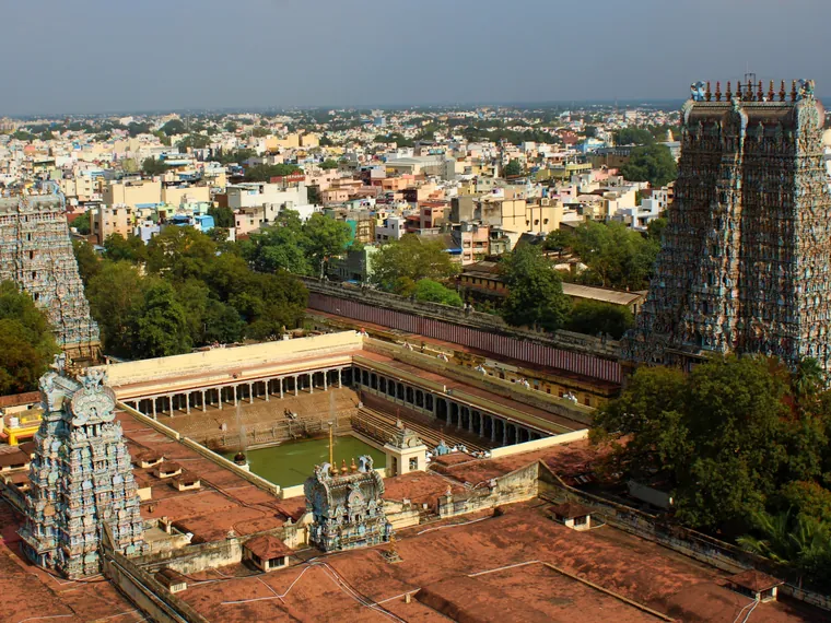 A carved gopuram of the Meenakshi Amman Temple in Madurai covered in painted sculpture from base to finial