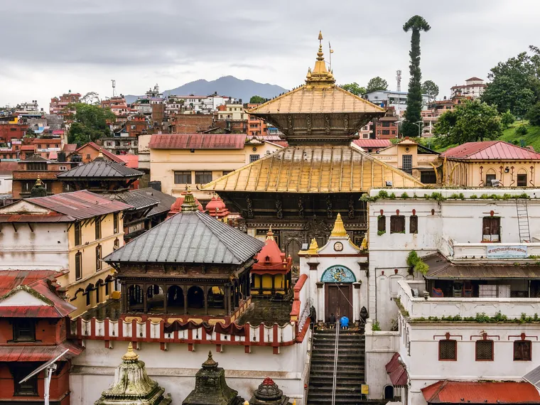 The pagoda roofs of the Pashupatinath Temple complex in Kathmandu rising above the buildings around the Bagmati river