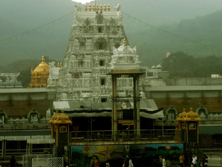 The gopuram and outer wall of the Tirumala Venkateswara Temple with the Seshachalam hills behind it
